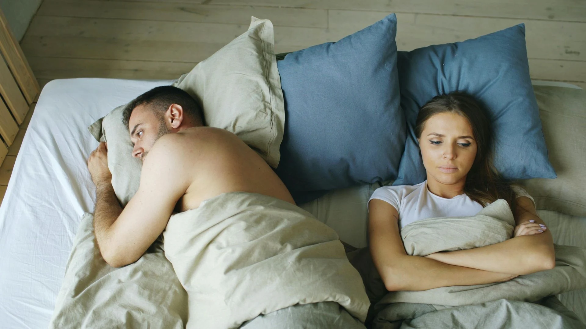 Two people sitting apart, looking in different directions